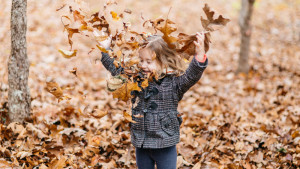 young-girl-playing-fall-leaves-081116-HERO